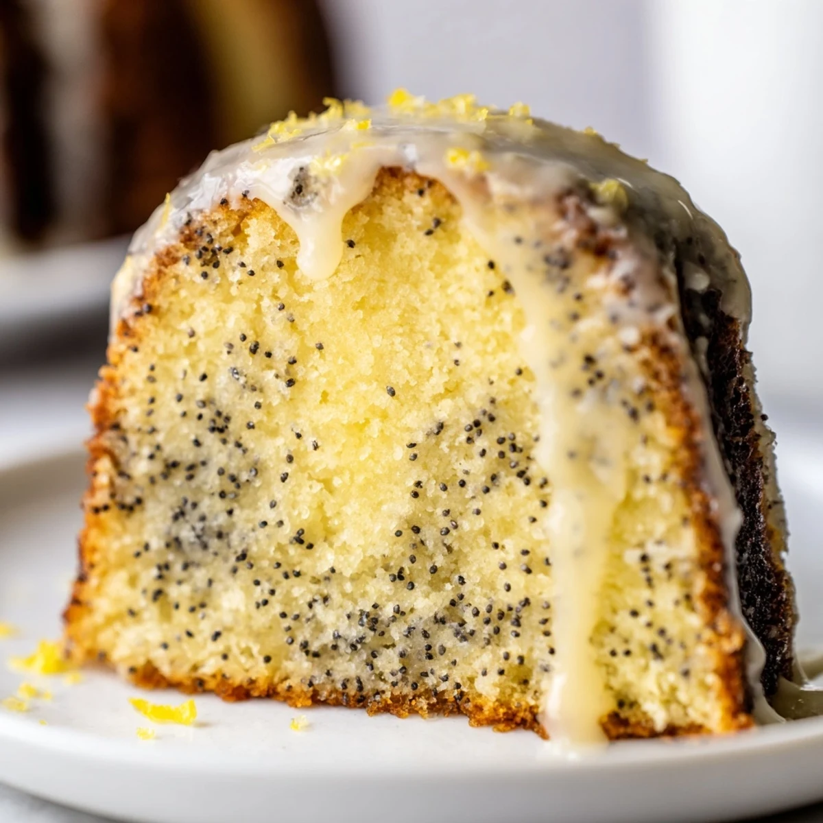 Freshly baked Lemon Poppy Seed Bundt Cake cooling on a wire rack with shiny lemon glaze dripping down the fluted edges.