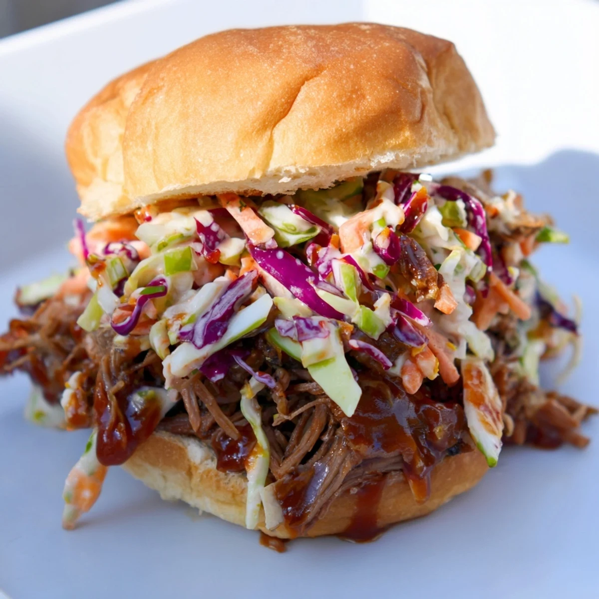 Golden toasted buns hold juicy Beef Brisket Sliders, garnished with fresh slaw and sauce.