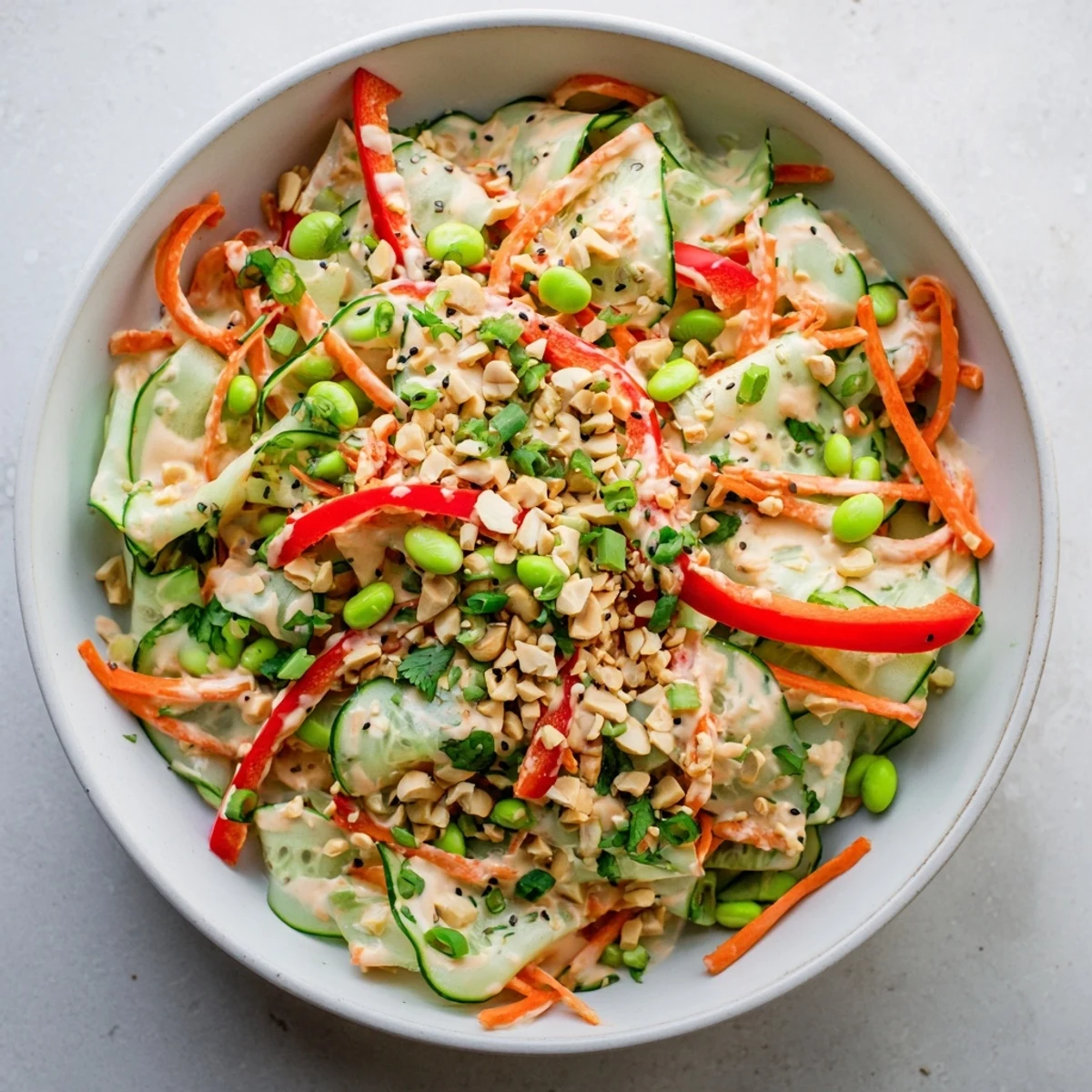 A light Creamy Asian Cucumber Bowl with crisp cucumbers, edamame, and a drizzle of tangy dressing.