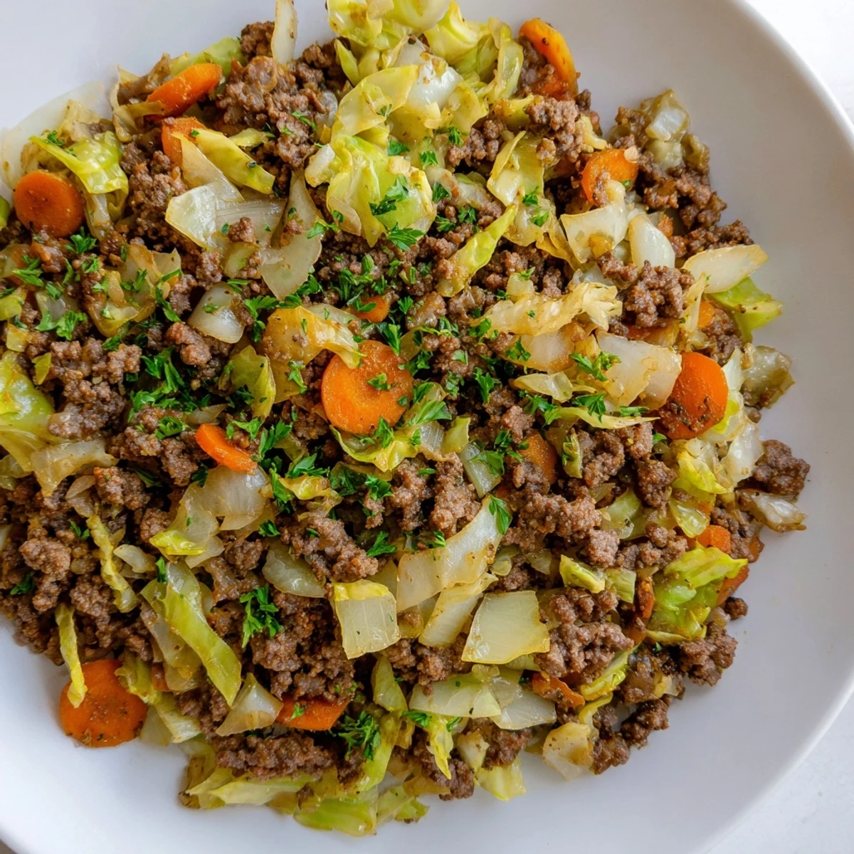 Golden brown Irish ground beef and cabbage dish served steaming hot with green cabbage pieces