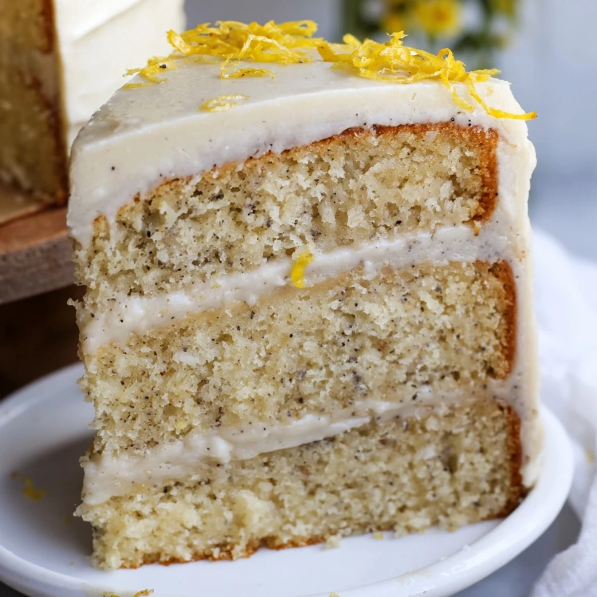 London Fog cake slice revealing Earl Grey infused layers with creamy vanilla bean frosting