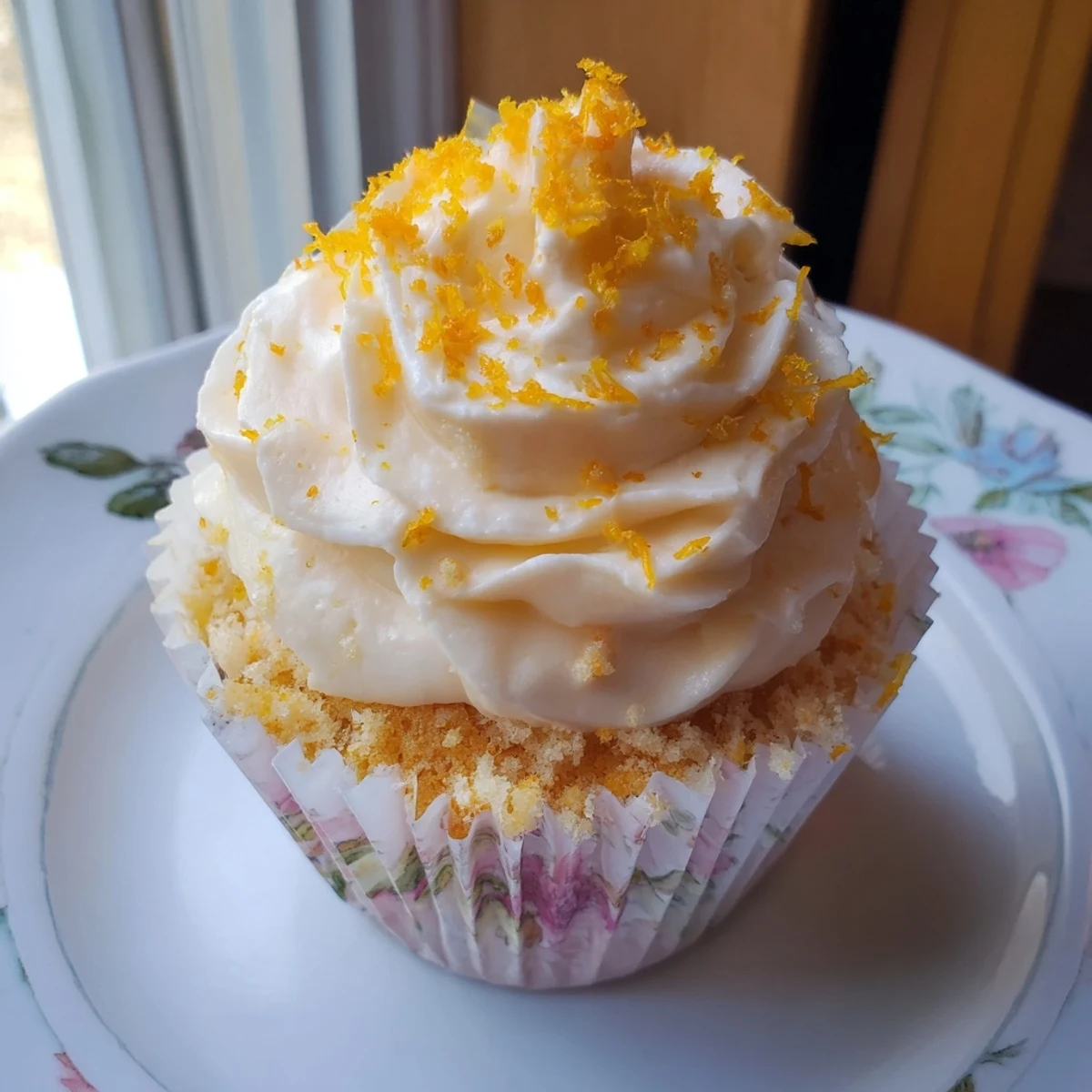 Fragrant floral cupcakes topped with creamy white frosting and delicate edible flower petals