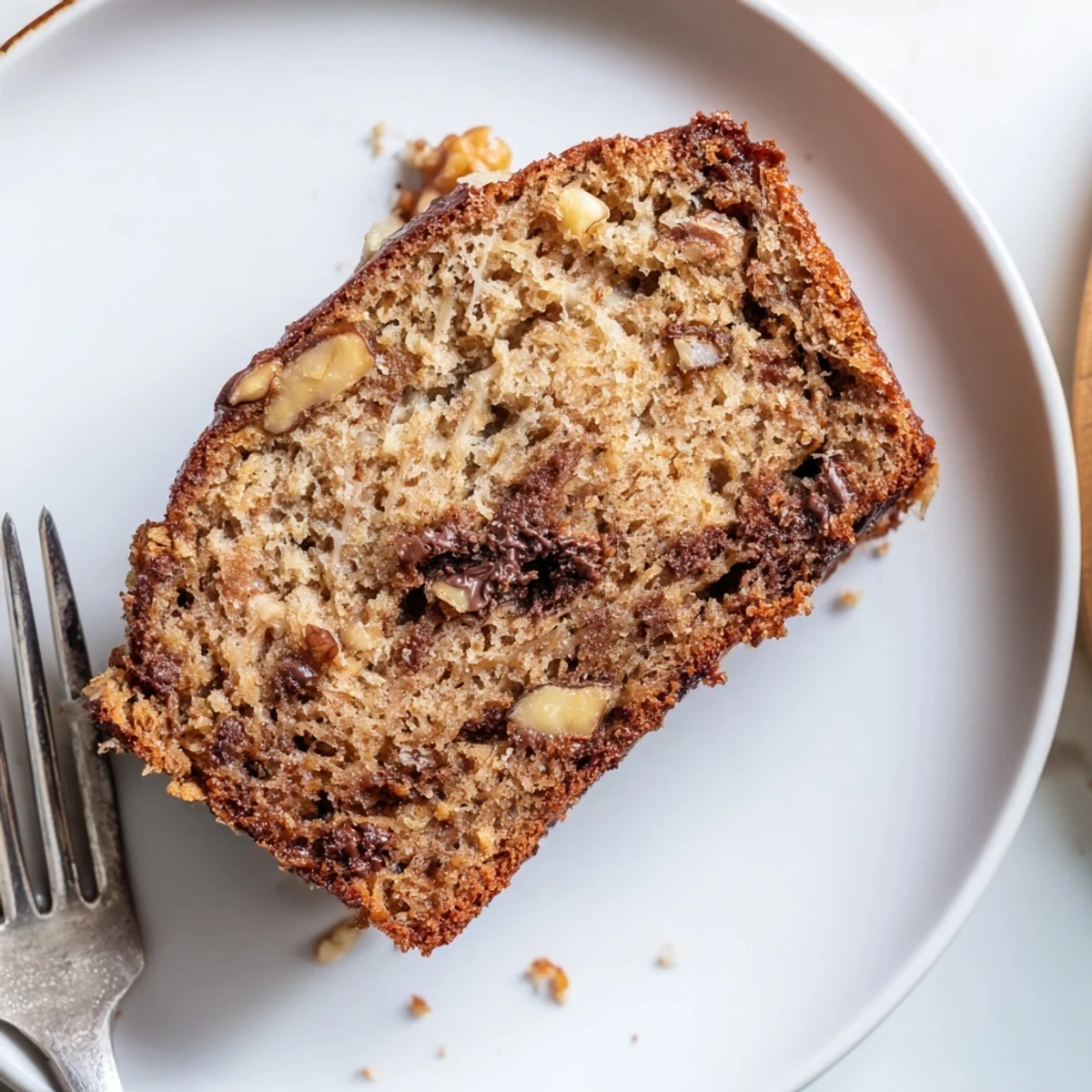Moist best ever banana bread served on a wooden board, perfect with morning coffee