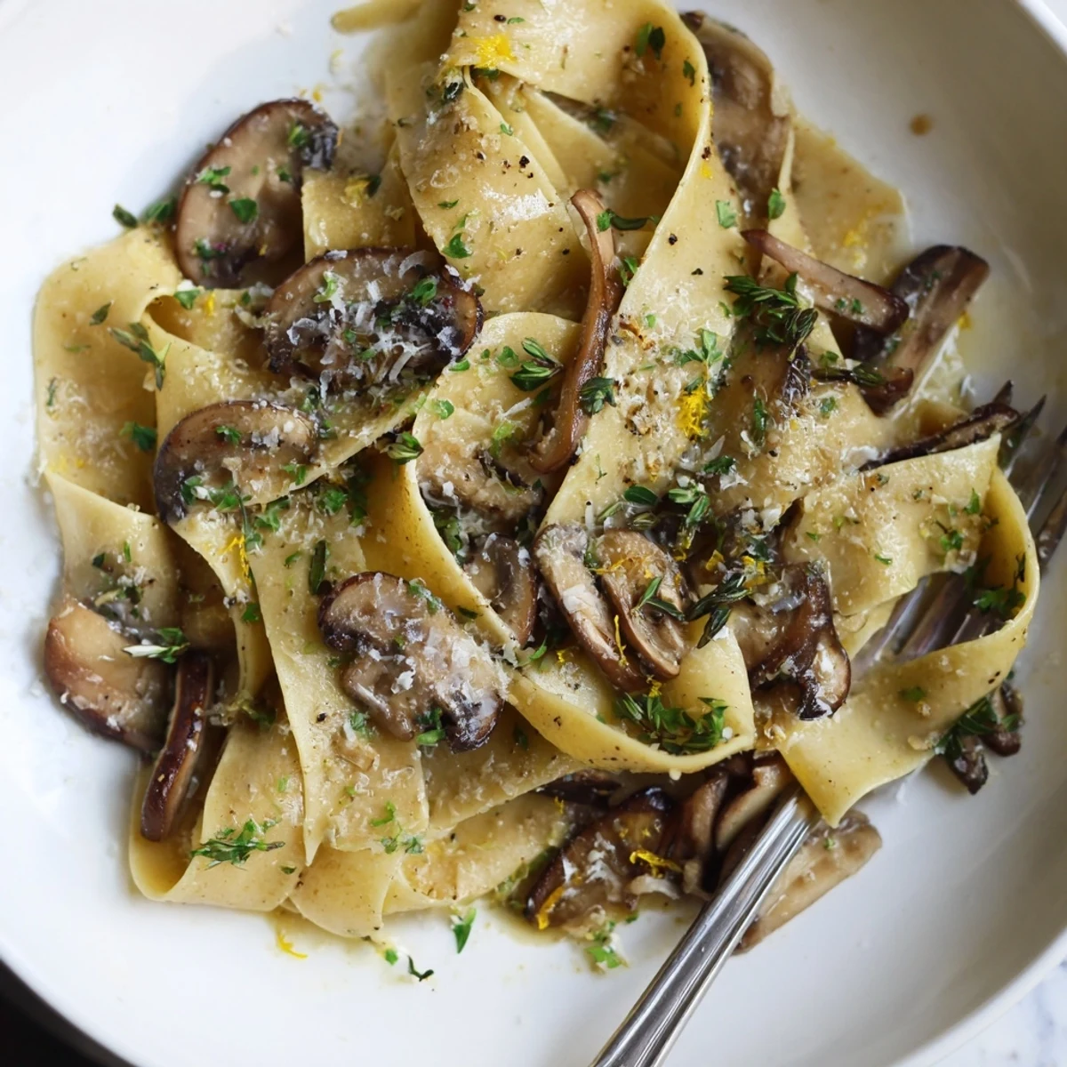 Wide pappardelle noodles tossed with sautéed mushrooms, garlic, and herbs in a buttery white wine sauce