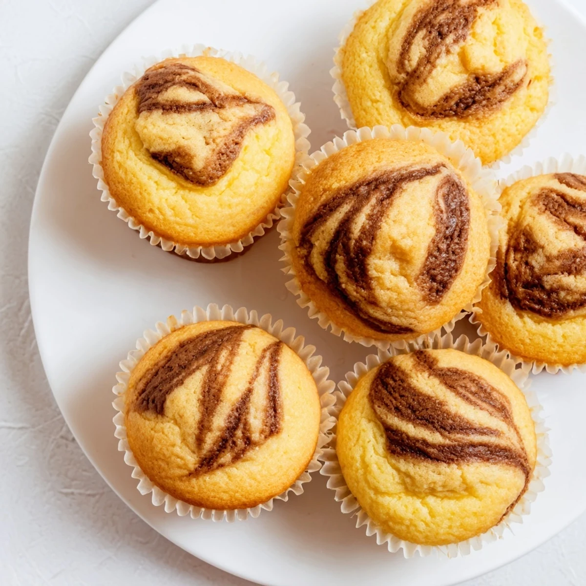 Golden brown Nutella banana muffins with chocolate hazelnut swirls baked to fluffy perfection
