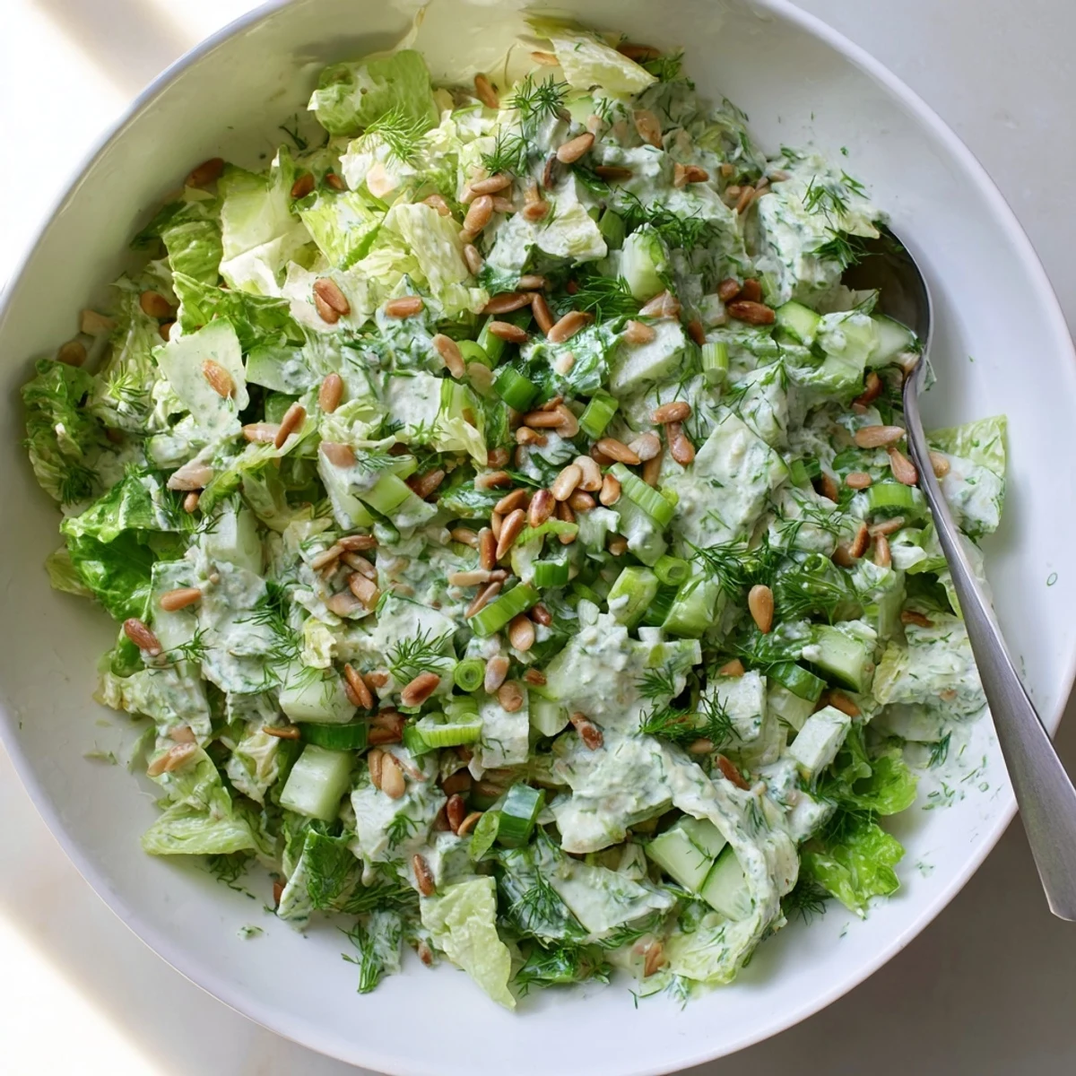 Fresh Green Goddess salad bowl with creamy herbed dressing and crisp mixed vegetables