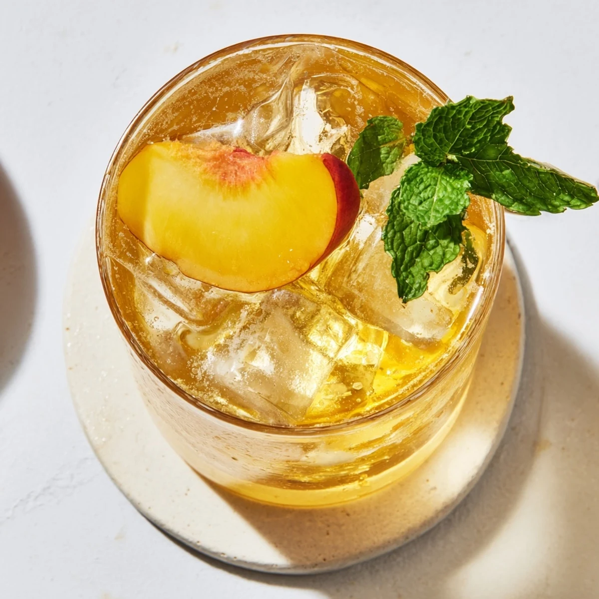Golden peach puree swirls with ginger syrup topped with sparkling water bubbles