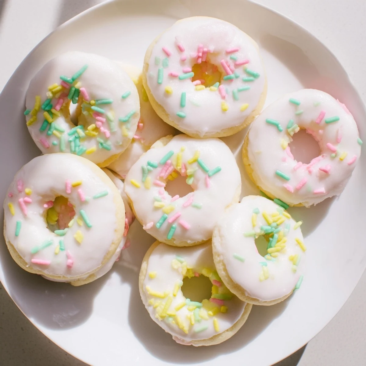 Traditional Italian Easter cookies arranged on serving platter with festive sprinkles and vanilla drizzle
