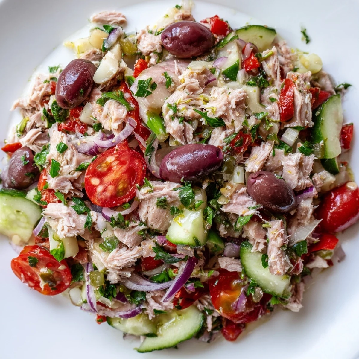 Simple Mediterranean Tuna Salad served on a platter dotted with Kalamata olives and fresh parsley