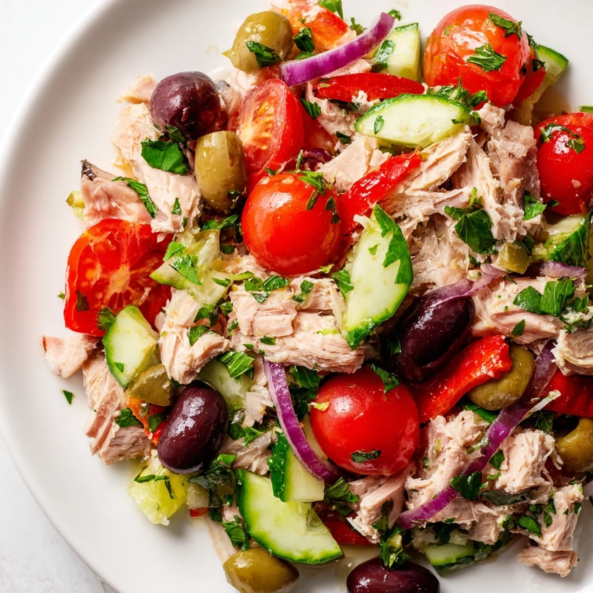 A vibrant Mediterranean Tuna Salad in a bowl with crisp cucumbers and roasted red peppers