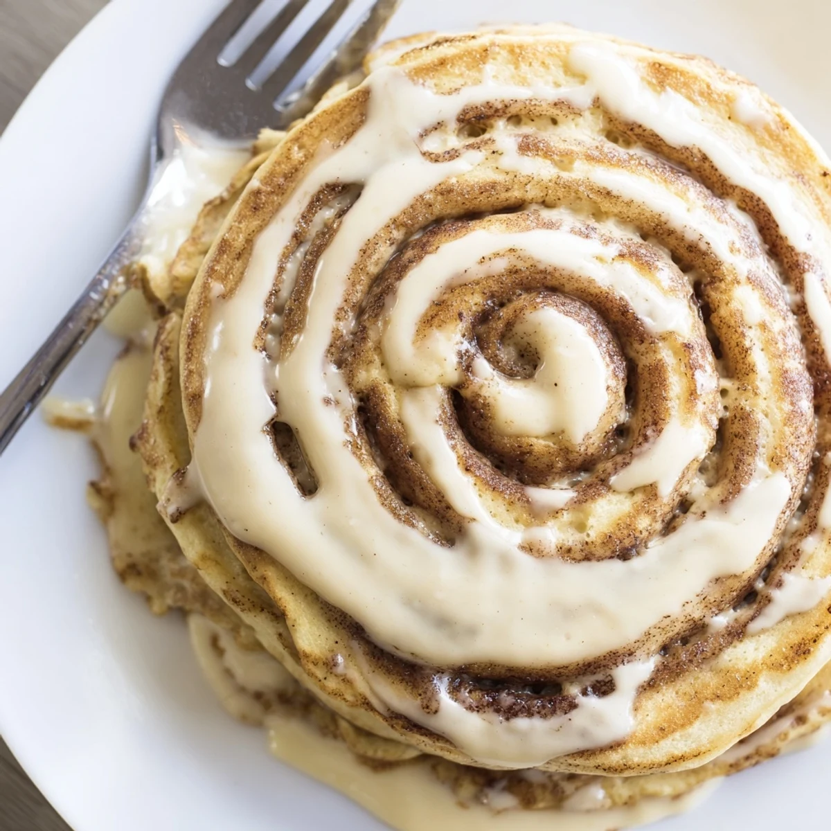 Fluffy pancakes swirled with warm cinnamon sugar topped with creamy icing