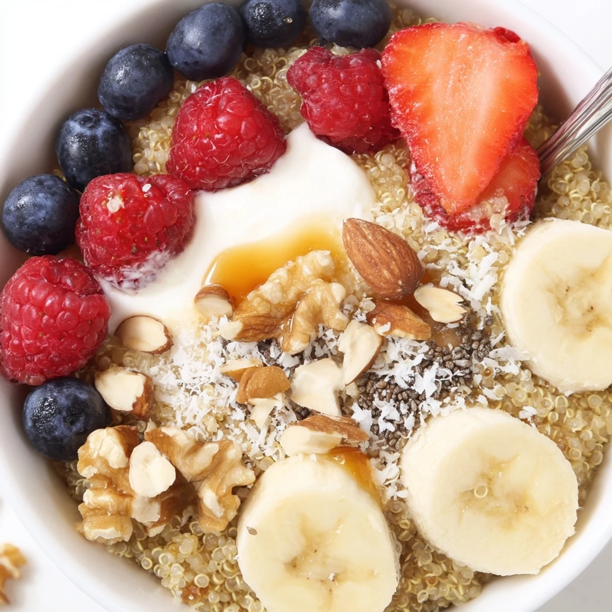 Quinoa Breakfast Bowl with fluffy quinoa, creamy yogurt, and fresh berries.