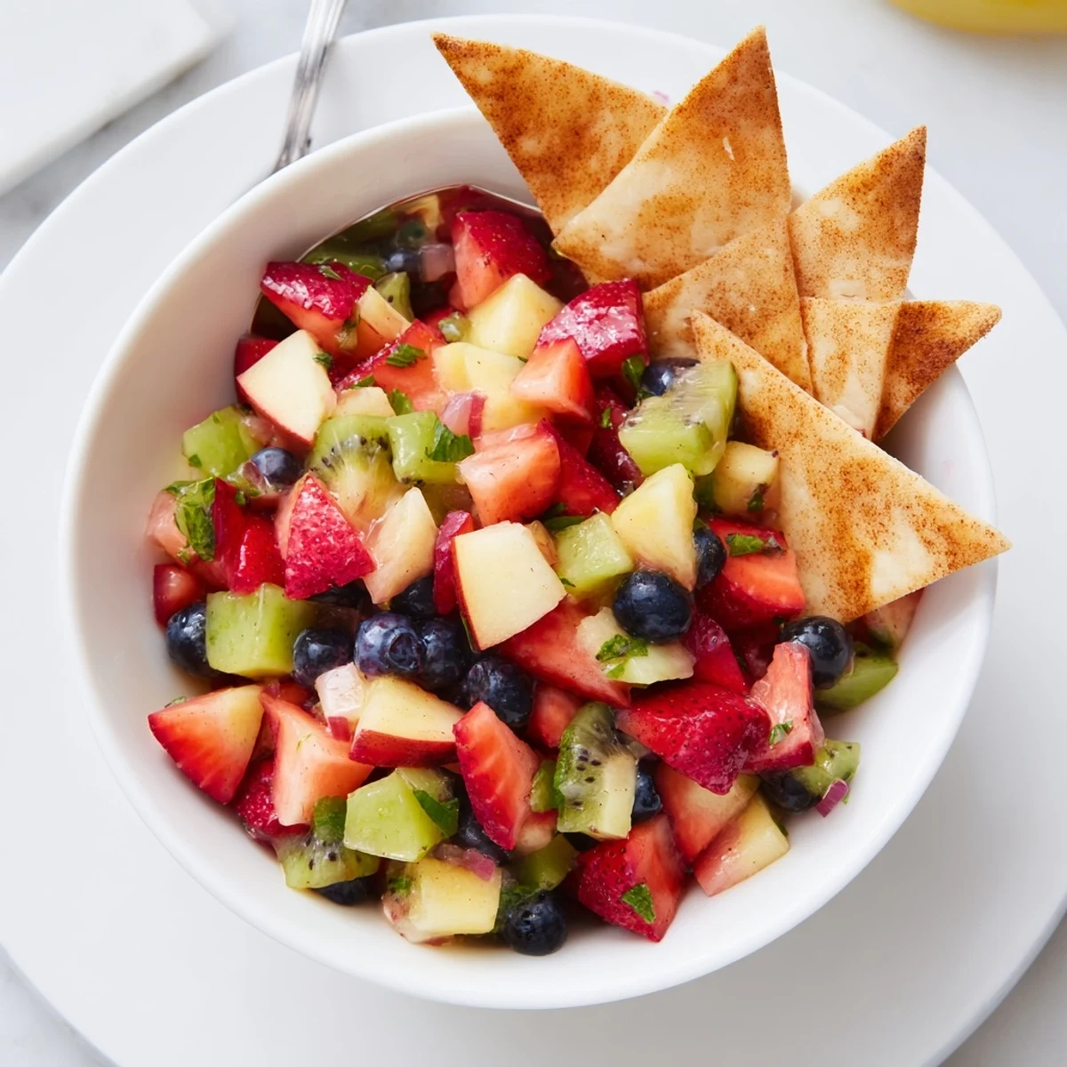 Fruit Salsa With Cinnamon Sugar Tortilla Chips served at parties with juicy, colorful fruit.