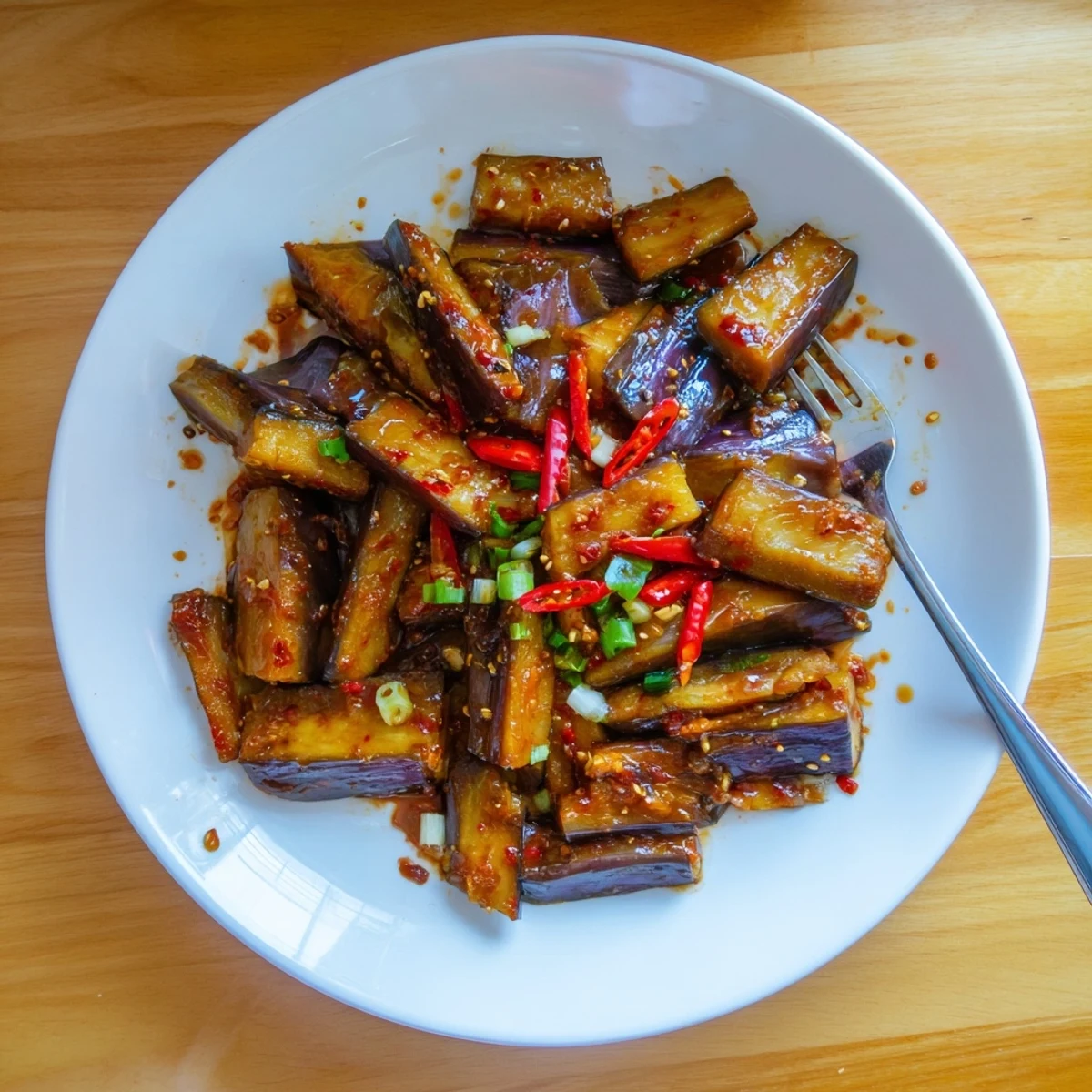 Tender batons of vegetables glazed with sesame — Sichuan Style Braised Aubergines, aromatic.