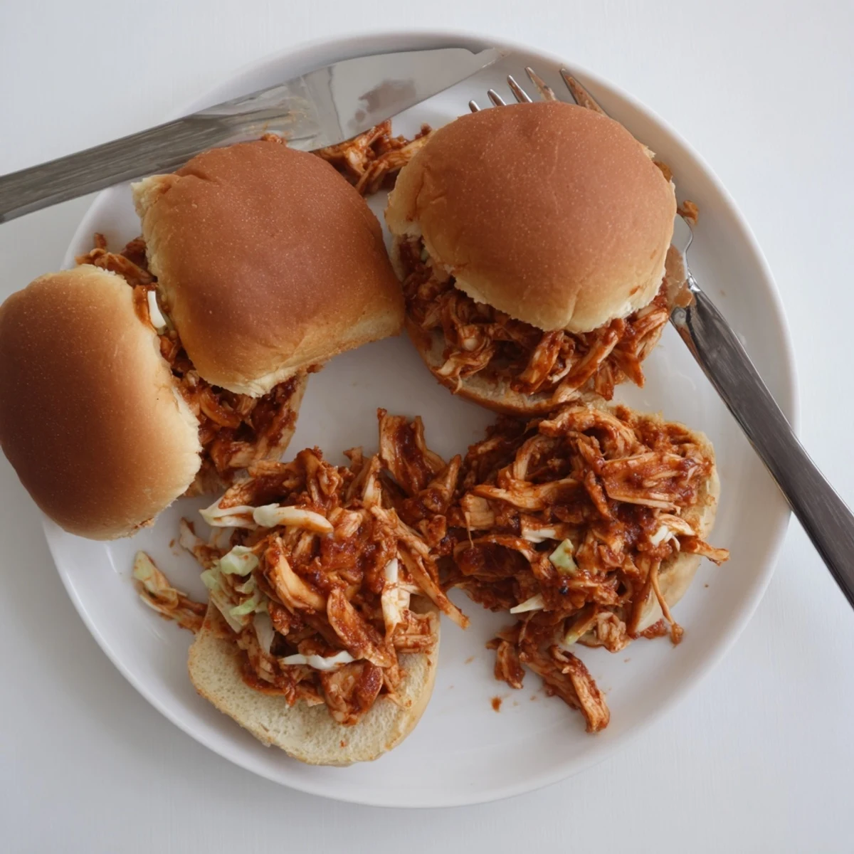 Tender shredded chicken in smoky barbecue sauce served on soft sweet Hawaiian slider rolls