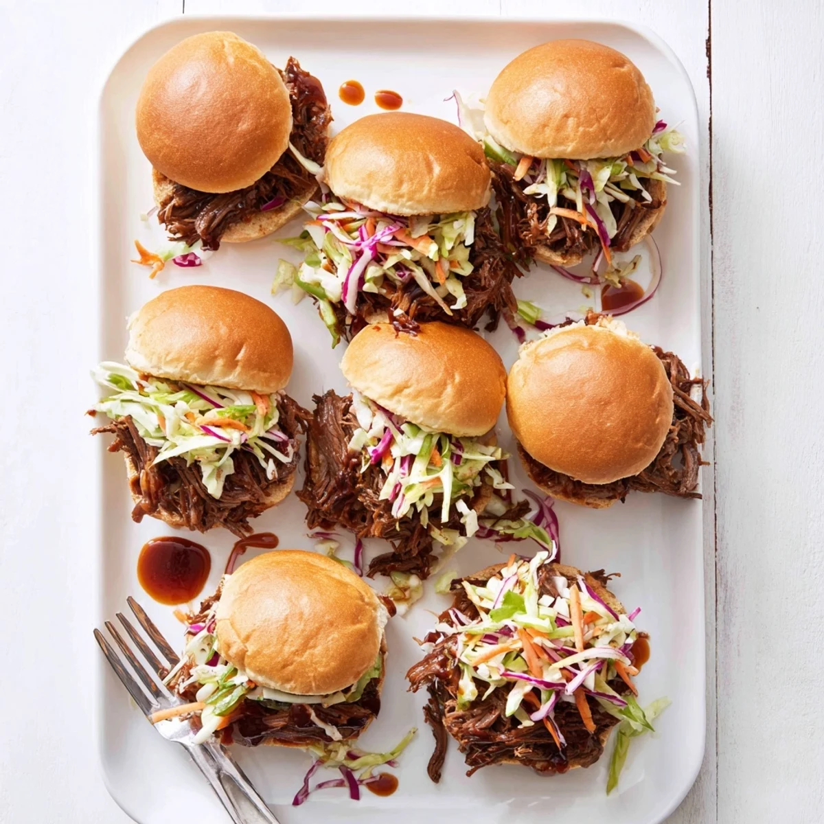 Mouthwatering BBQ pulled beef stacked in soft brioche buns topped with fresh coleslaw