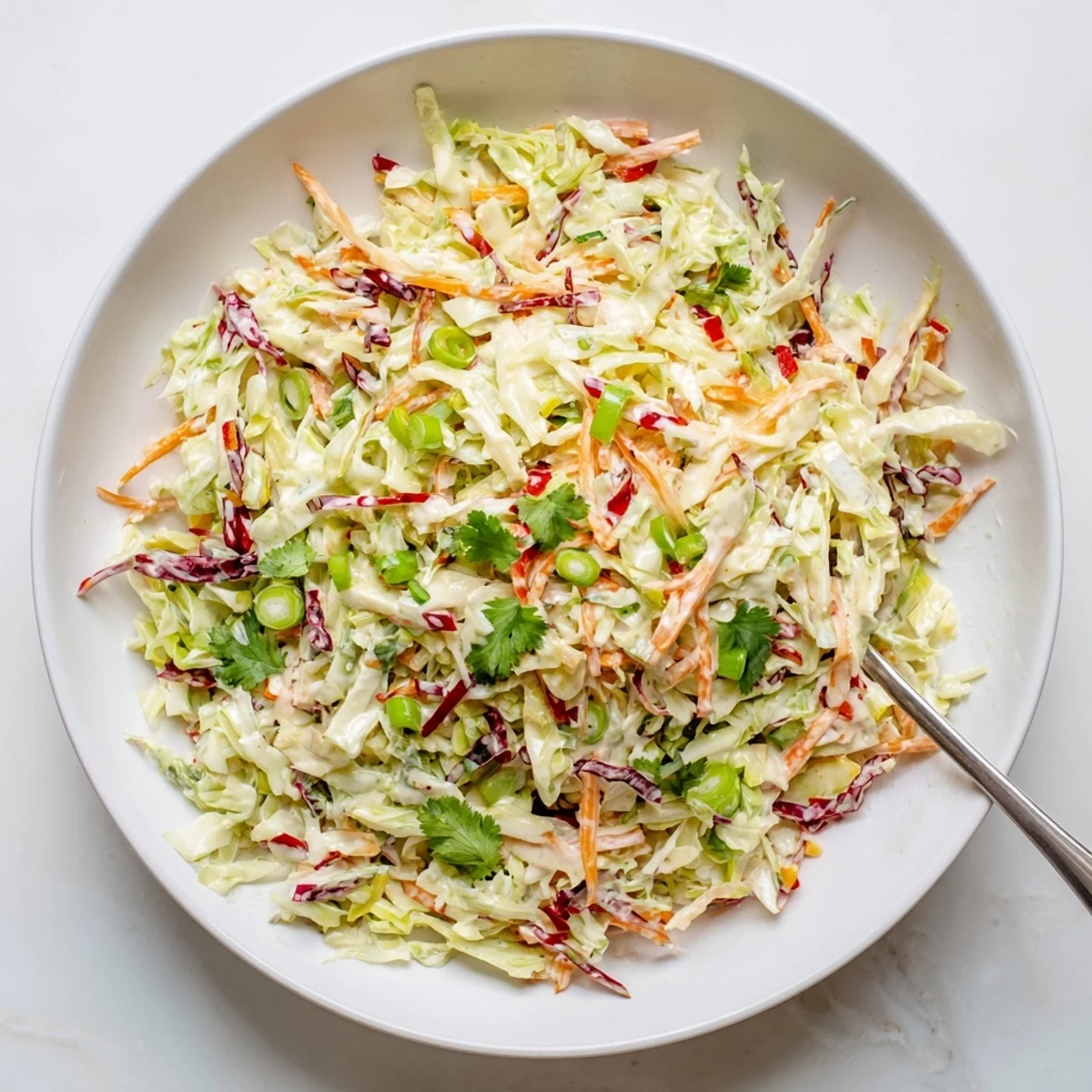 Colorful summer slaw featuring crunchy red and green cabbage tossed in creamy honey mustard dressing