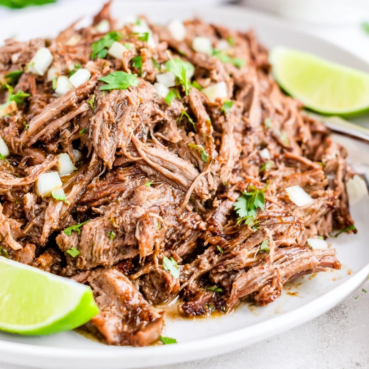 Slow Cooker Beef Barbacoa piled on warm corn tortillas, steamy and juicy.