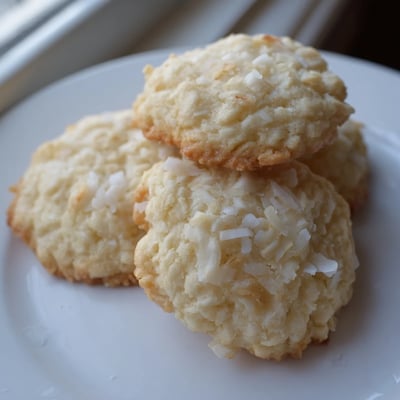 Soft and buttery coconut cookies topped with shredded coconut close-up shot